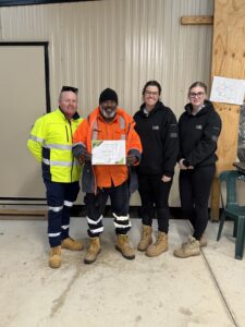 Epesio “Eps” Hankin, a Torres Strait Islander traffic controller, stands alongside Bianca Smith, Stephanie Hebden, and Timothy Ferrier at the Mulgoa Road Upgrade project site.